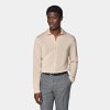 This sand long-sleeve polo cardigan is tailored in a slim fit and features a polo collar, full placket with a 7-button closure, and lightweight fabric for stylish, comfortable wear.