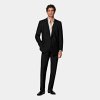 This black suit is cut to a tailored fit, offering a slim chest and waist for a fitted silhouette with padded shoulders. Paired with straight-leg trousers featuring a mid-rise and flat front.