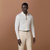 The warmth and comfort of a cardigan meets the relaxed versatility of a polo in this dynamic off-white knit—pair it with a blazer or wear it untucked on its own, it's perfect for any elevated casual occasion.